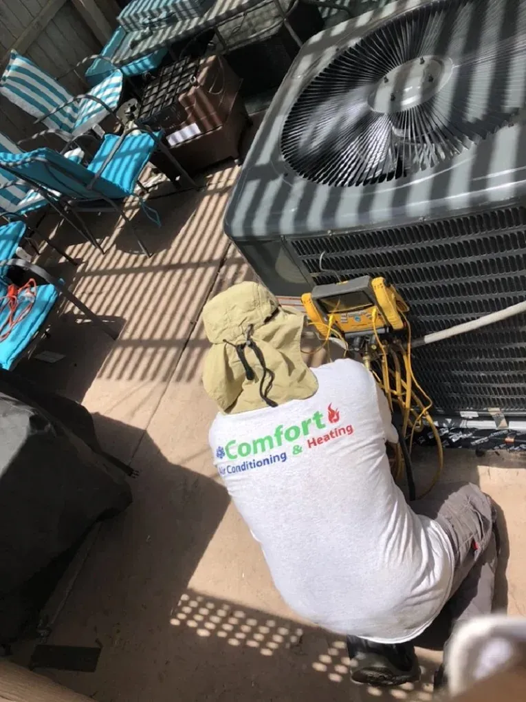 Comprehensive Guide to Air Conditioner Repair Services 3 Technician performing maintenance on an air conditioning unit, emphasizing routine cleaning practices